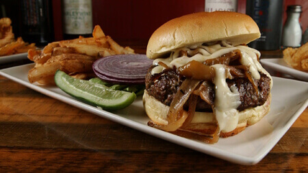 Tuckaway Tavern and Butchery signature dishes Award-Winning Steak Tips, Rooster Balls, Over The Top Lobster Rolls, Fresh Ground Burgers